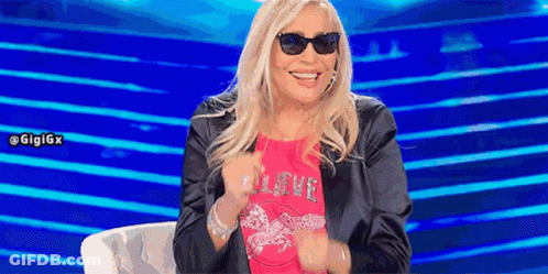 Woman In Sunglasses And Pink Shirt Saying Love GIF