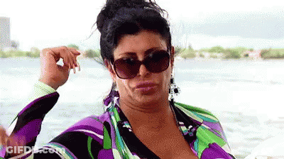 Woman In Sunglasses And Purple Dress On Boat GIF