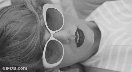 Woman In Sunglasses And Red Lipstick Lying Down GIF