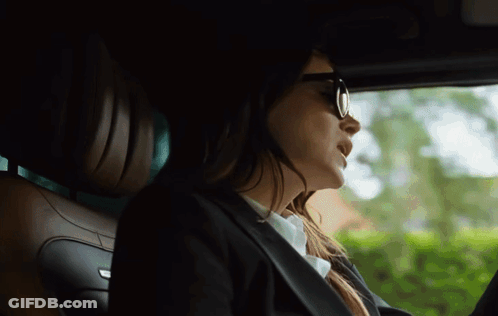 Woman In Sunglasses And Suit Driving Car GIF