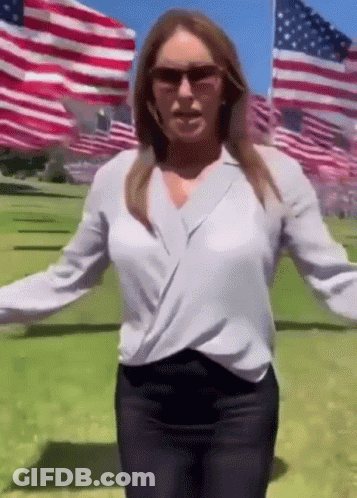 Woman In Sunglasses And White Shirt In American Flag Field GIF