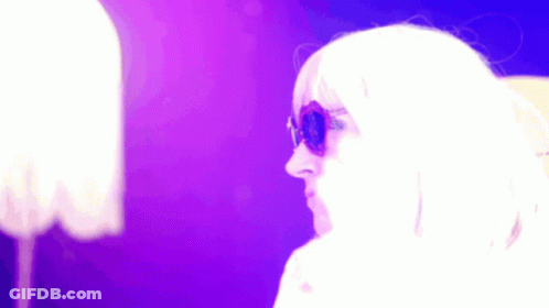 Woman In Sunglasses And White Wig Against Purple Background GIF