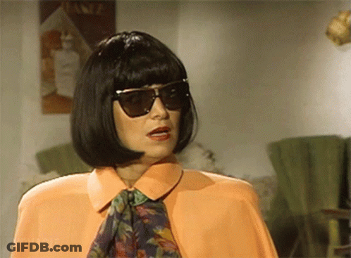 Woman In Sunglasses And Wig In Front Of Lotion Sign GIF