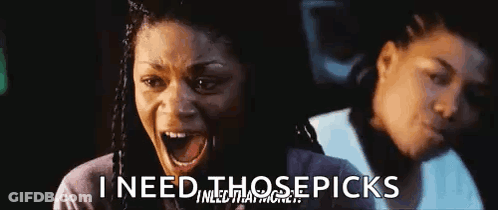 Woman In Sunglasses And Wig Smiling At Another Woman GIF