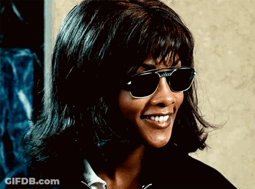 Woman In Sunglasses And Wig Smiling GIF