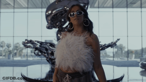 Woman In Sunglasses At Large Window GIF