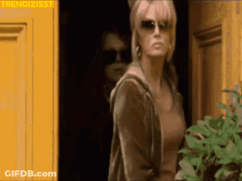 Woman In Sunglasses At Yellow Door GIF