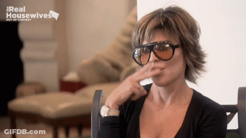 Woman In Sunglasses In Front Of Real Housewives Sign GIF