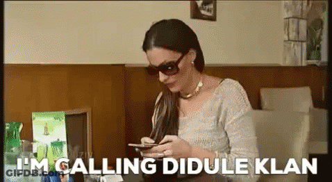 Woman In Sunglasses Looking At Phone Saying I'm Calling Dibule Klan GIF