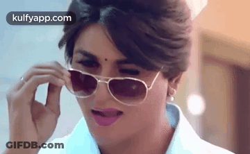 Woman In Sunglasses Making A Face GIF