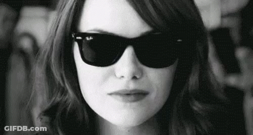 Woman In Sunglasses Making Face In Black And White GIF