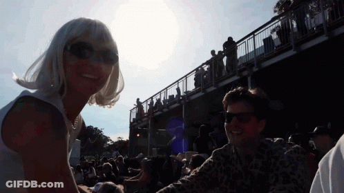 Woman In Sunglasses Next To Man In Crowd GIF