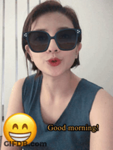 Woman In Sunglasses Saying Good Morning With Smiley GIF