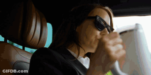 Woman In Sunglasses Sitting In Driver Seat GIF