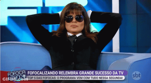 Woman In Sunglasses Sitting On Couch With Hands Behind Head In Front Of SBT Logo GIF