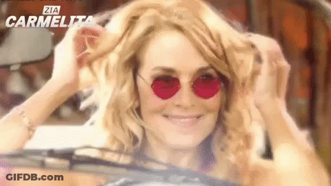 Woman In Sunglasses Smiling In Car GIF