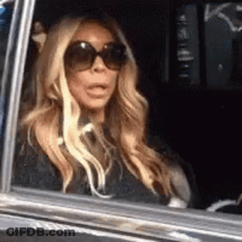 Woman In Sunglasses Surprised In Car GIF