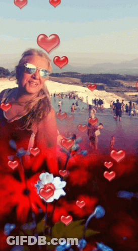 Woman In Sunglasses Surrounded By Hearts And Flowers GIF