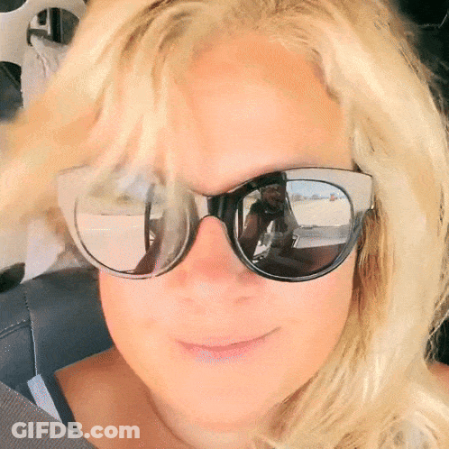 Woman In Sunglasses Taking Selfie In Mirror GIF
