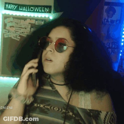 Woman In Sunglasses Talking On Phone GIF
