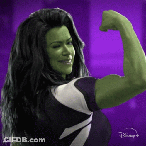 Woman In Superhero Costume Flexing Muscles GIF