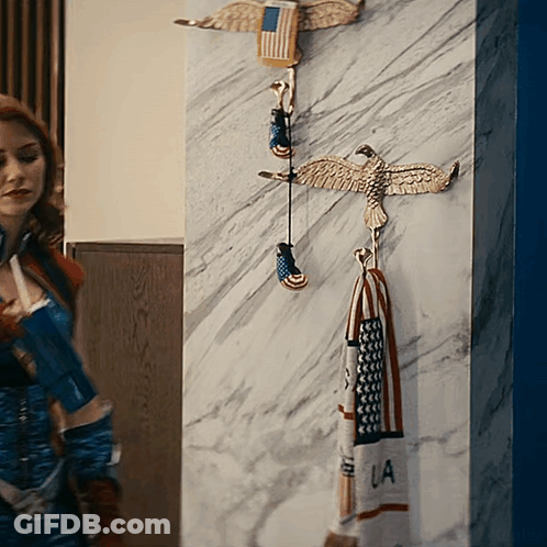 Woman In Superhero Costume In Front Of Wall With Eagles And LA Towel GIF