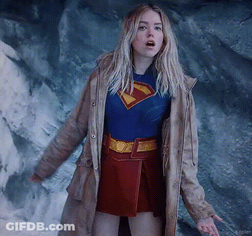 Woman In Superman Costume And Trench Coat GIF