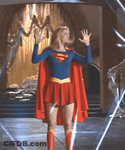 Woman In Superman Costume Before Chandelier GIF