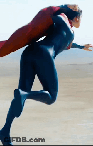 Woman In Superman Costume Running On Beach GIF