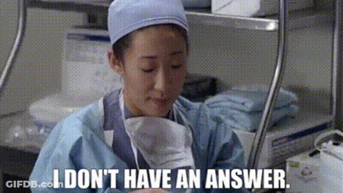 Woman In Surgical Gown Holding Paper Saying I Don't Have An Answer GIF