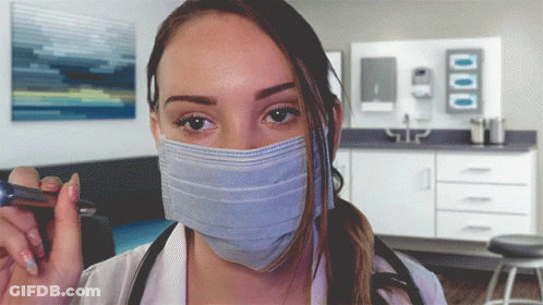 Woman In Surgical Mask Holding Pen GIF