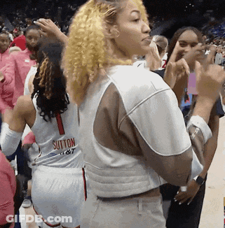 Woman In Sutton Jersey Standing In Crowd GIF