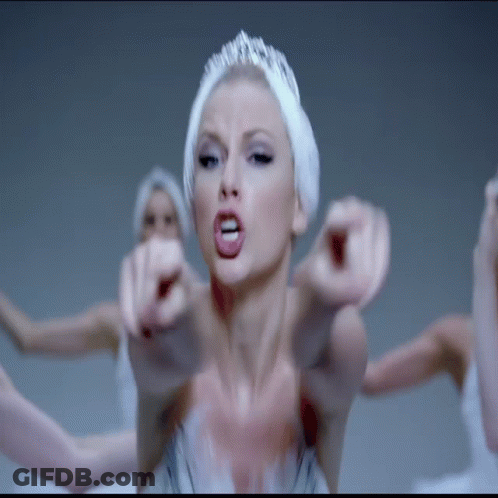 Woman In Swan Costume Pointing At Camera GIF