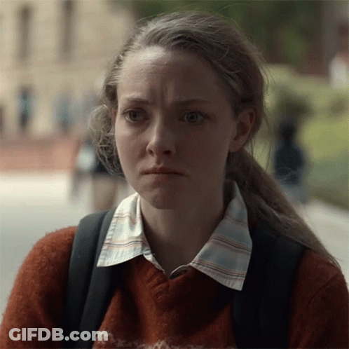 Woman In Sweater And Backpack Looking At Camera GIF