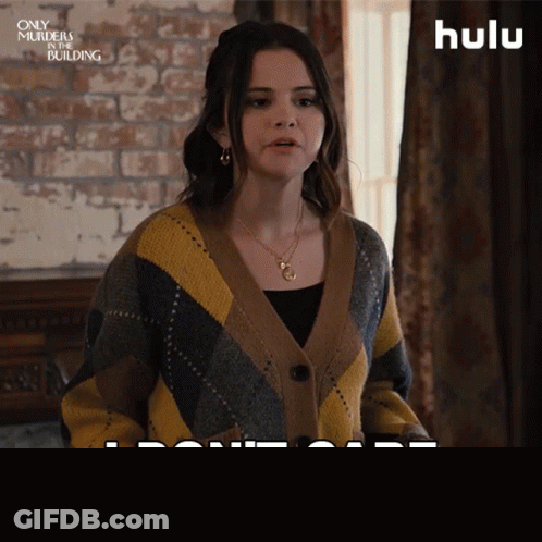 Woman In Sweater Saying I Don't Care GIF