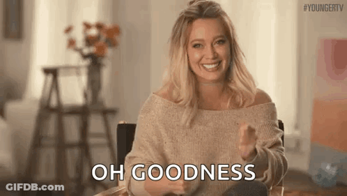 Woman In Sweater Sitting In Chair Thumbs Up GIF