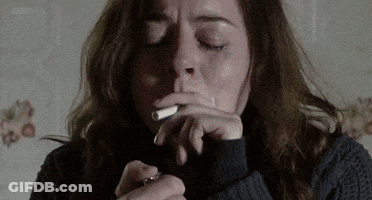Woman In Sweater Smoking Cigarette GIF