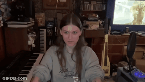 Woman In Sweatshirt Saying A Playing Keyboard GIF