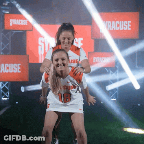 Woman In Syracuse Jersey Carrying Another Woman GIF