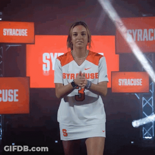 Woman In Syracuse Jersey In Front Of Syracuse Signs GIF