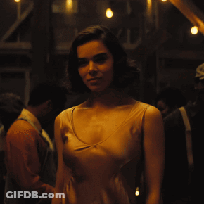 Woman In Tan Tank Top In Crowd GIF