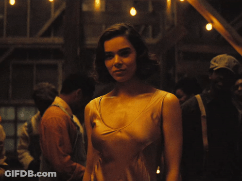 Woman In Tan Tank Top In Crowd GIF