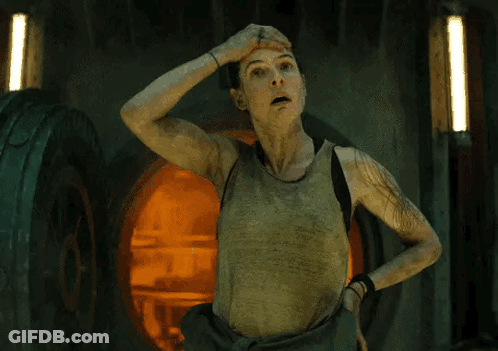 Woman In Tank Top Hand On Head In Dark Room GIF