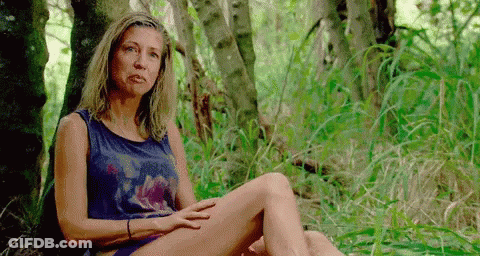 Woman In Tank Top Sitting In Woods GIF