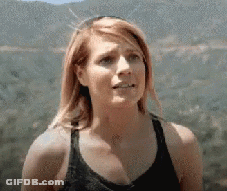 Woman In Tank Top Standing In Front Of Mountain GIF