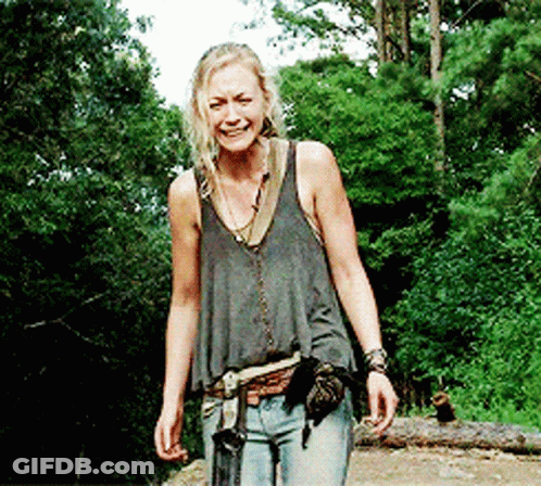 Woman In Tank Top Walking Through Woods GIF