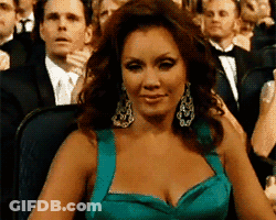 Woman In Teal Dress Sitting In Crowd GIF