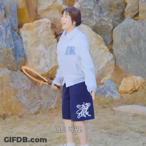 Woman In Teddy Jamming Jacket And Shorts By Rocks GIF