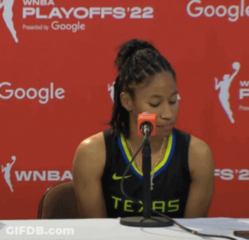 Woman In Texas Jersey Sitting At Table With Google Sign GIF