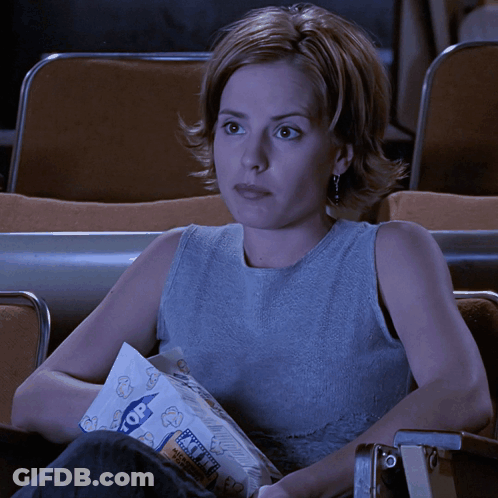 Woman In Theater Holding Popcorn GIF